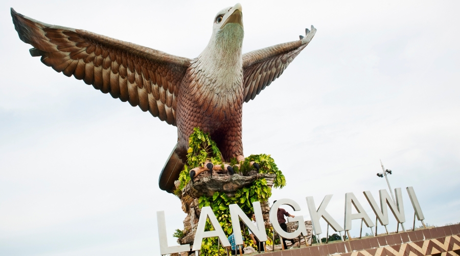 "Iconic eagle statue at Eagle Square in Kuah, Langkawi overlooking the ocean.